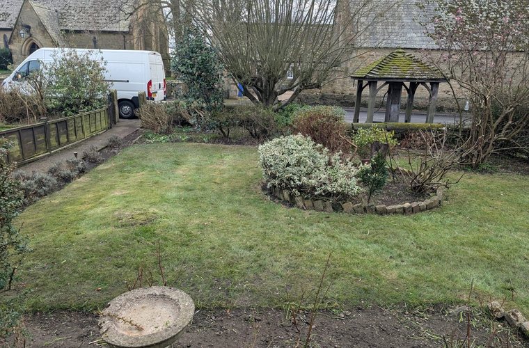 Formal garden with clipped shrubs, beds and a shelter