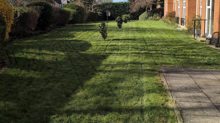 Mown verge and path running alongside housing